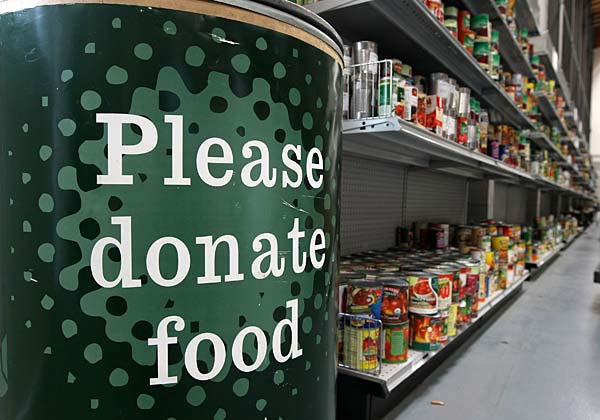 
                A donation bin sits near shelves with canned foods at the San Francisco Food Bank in San Francisco.
                                    (Justin Sullivan/Getty Images)
                                