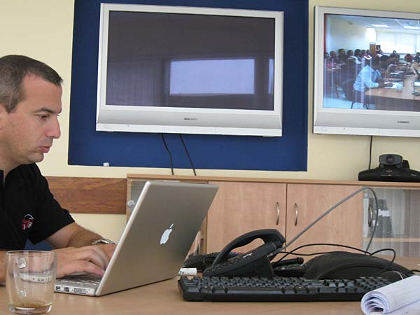 
                CEO Zvi Schreiber works in the Israel office during the daily video conference with the Palestinian office.
                                    (Daniel Estrin)
                                