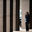 A woman walks past Goldman Sachs headquarters