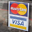 A window sticker advertising Visa and MasterCard