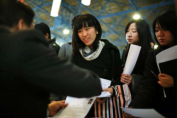
                Job seekers hand in their resumes at a job fair for postgraduate students this week in Beijing. Nearly 40,000 applicants competed for approximately 14,200 positions at the fair.
                                    (China Photos/Getty Images)
                                