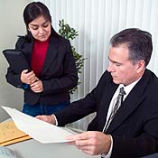 A lawyer shows a woman a legal document 