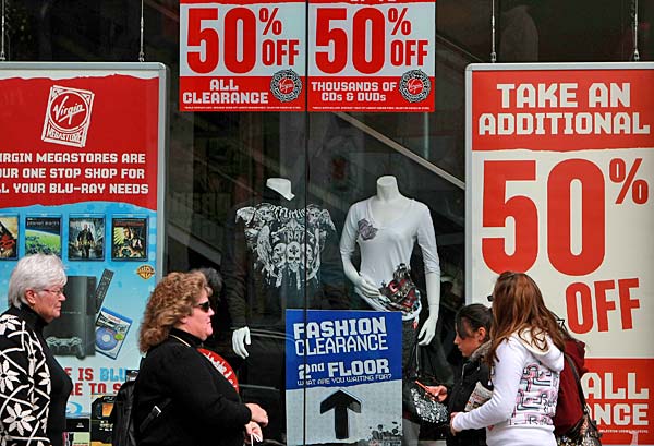 
                Pedestrians walk by sale signs in the window at the Virgin Megastore in San Francisco.
                                    (Justin Sullivan/Getty Images)
                                