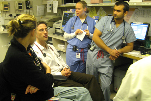 
                    At the end of the Friday night shift, the doctors and interns and residents 'pass off' to the overnight shift.  They go over each patient and discuss how they've cared for each patient in ER care.
                                            (Curt Nickisch)
                                        