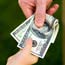 Parent hands a child a wad of cash
