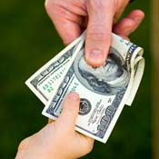Parent hands a child a wad of cash 