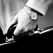 Equity Private's hand holding a briefcase. 