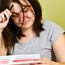 A stressed out woman holds a bill