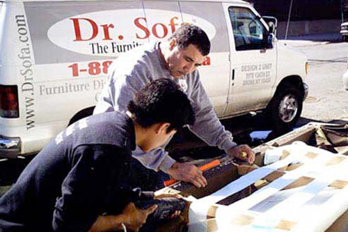 
                    Dr. Sofa (Greg Gomez and Mario Quito) get ready to slice apart a sofa to fit it into a New York City apartment.
                                            (Shlomi Eini)
                                        