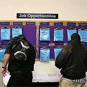 Job seekers look at a job board 