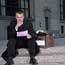 A man looks at his pink slip