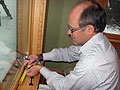 Keith Holtan working on a window