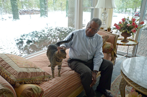 
                    Romey enjoys a quiet moment with the family cat, Mr. Stripes. He feels he now has a peace of mind, no matter what the economy has in store.
                                            (Desiree Cooper)
                                        