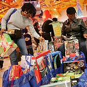 Shoppers checking over toys 