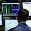 A stock trader watches a monitor at the NYSE