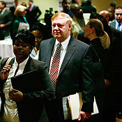 Job applicants stand in line at a career fair 