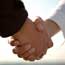 A man and woman shake hands