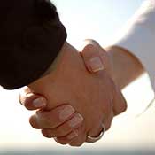 A man and woman shake hands 