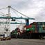 Cargo ships unload their shipping containers