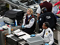 TSA officials conduct security screenings