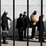 Job seekers wait in line for a job fair