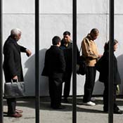 Job seekers wait in line for a job fair 