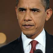 President Barack Obama listens to a question 