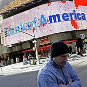 People walk past a Bank of America branch 