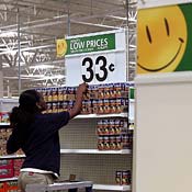 Wal-Mart employee Michelle Triplett stocks food 