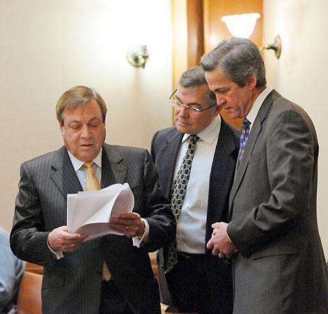 Republican Norm Coleman, right, looks on as his attorneys, Joe Friedberg, left, and Tony Trimble read a court order during a court delay before the start of the Senate vote recount trial Thursday, Feb. 26, 2009, in St. Paul, Minn.