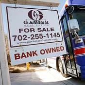 Bus drives by foreclosed home in Las Vegas, Nev. 
