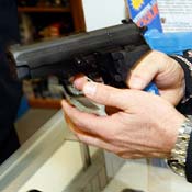 Testing a a semi-automatic pistol at a gun store 