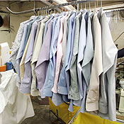 Clothes hang at a dry cleaning store 
