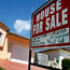 A for sale sign in front of a home in Miami