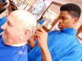 Barbering student with a customer