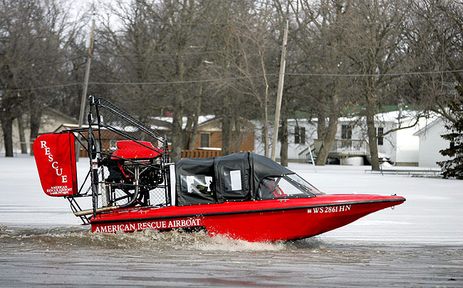 A rescue airboat moved to an evacuation area in the Oakport area Friday, March 27, 2009.