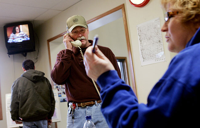 With Ann Zidon conducting personnel, Mike Smart, incident commander in Hendrum, Minnesota, talked on the phone in the town's civic center Monday, March 30, 2009.