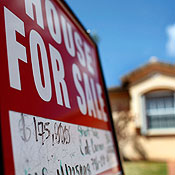 A for sale sign in front of a home in Miami 