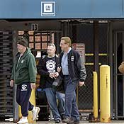 General Motors workers leave a GM plant 