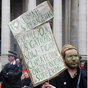 Protestor and policeman before G-20 in London 