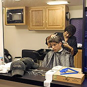 A Google employee has his hair cut 