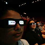People wearing 3-D glasses at a film festival 