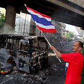An anti-government protester waves a Thai flag 