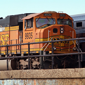 A BNSF engine pulls a train loaded with coal 