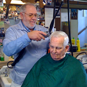 Barber Rich McCarty cutting Bob Semb's hair 