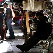 A vendor waits for customers at a market in Mexico 