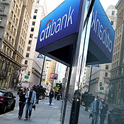Pedestrians walk by a Citibank branch 