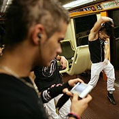 Teenagers perform a tecktonik dance in a subway 