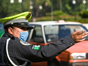 A traffic officer wears a mask to protect herself from a swine flu outbreak in Mexico City on April 24.