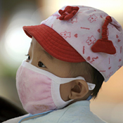 A baby wearing a mask at a hospital in Beijing 